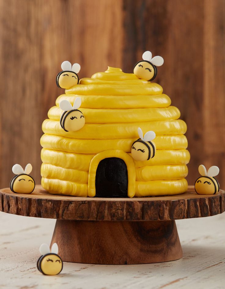 a cake made to look like a beehive with bees around it