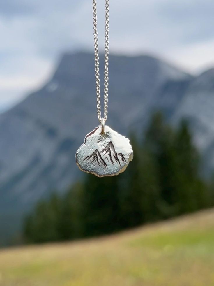 Remember your personalized journey through loss or challenging circumstances with a solid silver nugget engraved with a beautiful nature symbol. Hold your loss and link to nature close to your heart. Chose the symbol that resonates with you the most: -Daisy -Dandelion poof -Dragonfly -Footprints -Forget-me-not  -Mushroom -Mountains -Trees -Sand Dollars *1-2 Letters or Numbers able to be engraved on the back.  Each of these pendants is 100% unique. Made from high quality recycled silver, they are Personalized Silver Nature-inspired Jewelry, Etched Sterling Silver Jewelry As Gift, Spiritual Stamped Silver Jewelry, Sterling Silver Etched Jewelry As Gift, Sterling Silver Etched Jewelry For Gifts, Nature-inspired Stamped Jewelry For Everyday, Everyday Symbolic Hand Stamped Jewelry, Everyday Silver Nature-inspired Jewelry, Silver Engraved Nature-inspired Necklace