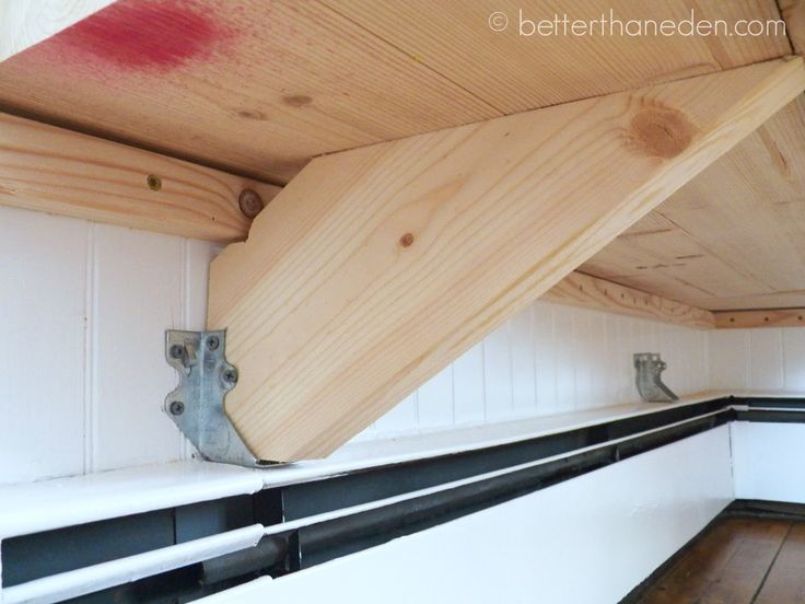 the inside of a boat with wood planks and metal brackets on it's sides