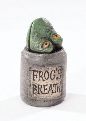 a frog's head is sitting on top of a jar with the words frog's breath