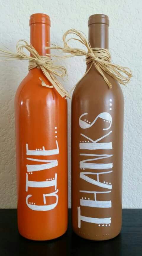 two orange and brown wine bottles sitting next to each other on top of a table