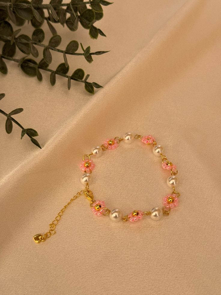 Made of seed beads,pearls and 14k golden line. Pink Flower-shaped Beaded Bracelets, Dainty Flower-shaped Bracelet With Colorful Beads, Elegant Flower-shaped Beaded Crystal Bracelet, Pink Flower-shaped Pearl Bracelet, Pink Flower-shaped Adjustable Crystal Bracelet, Seed Beads, Jewelry Bracelets, Bracelet, Beauty Book