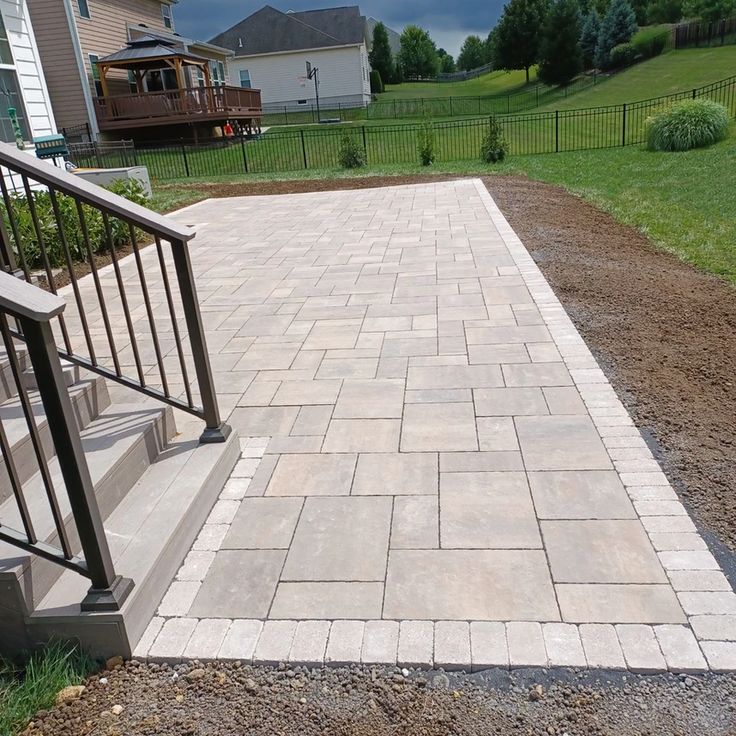 a patio with steps leading up to the house