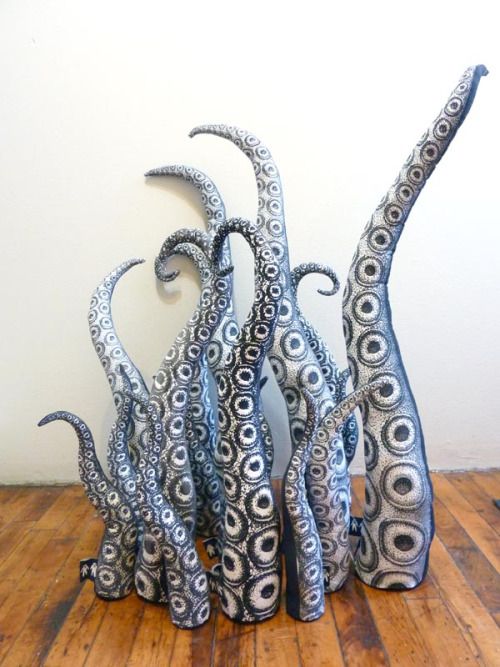 an octopus sculpture sitting on top of a wooden floor