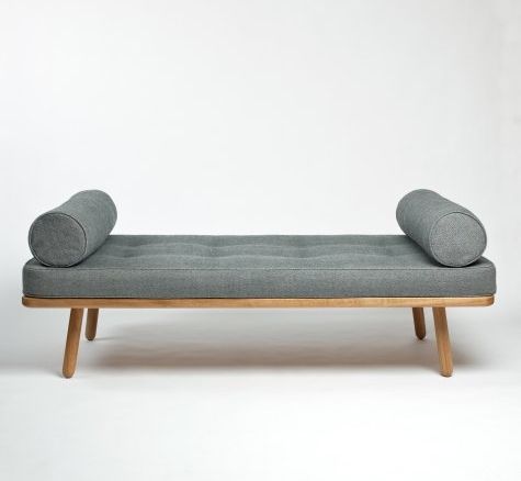 a gray couch sitting on top of a wooden frame