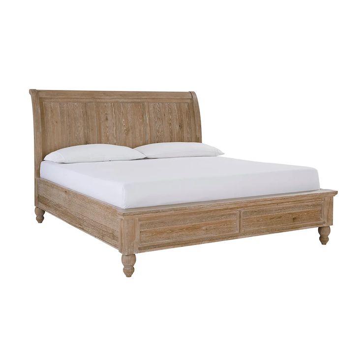 a wooden bed with white sheets and pillows