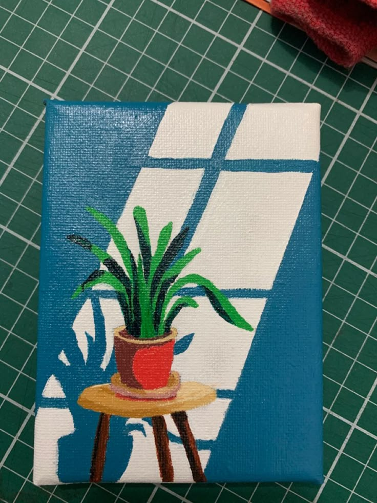 a potted plant sitting on top of a table next to a pair of scissors