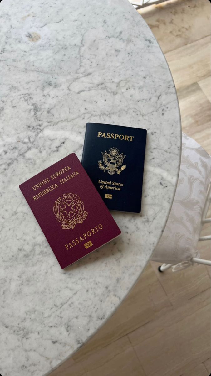 two passports sitting on top of a marble table