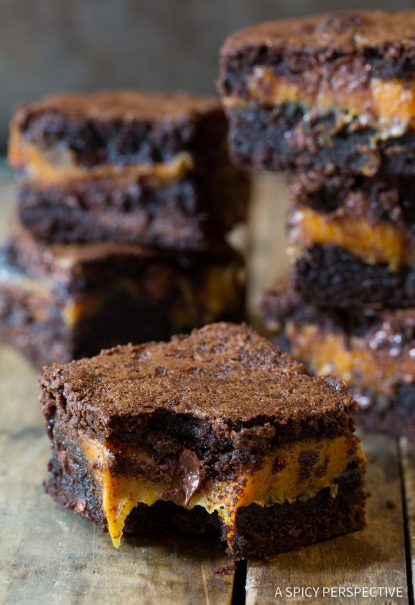 several pieces of brownie sitting on top of a wooden table next to each other