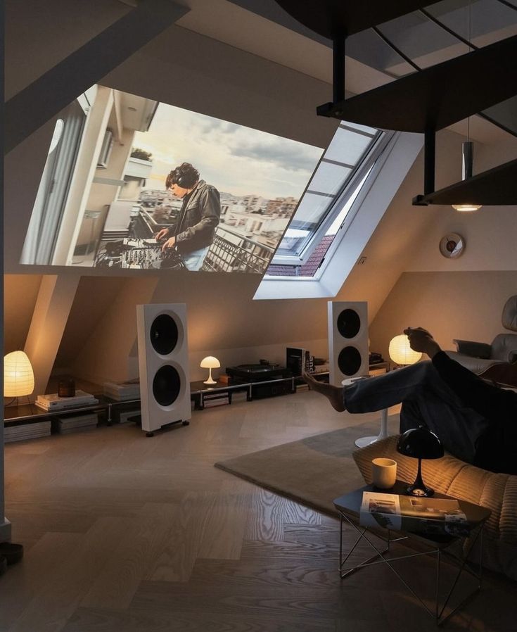 a man sitting on a couch in front of a projector screen while watching tv