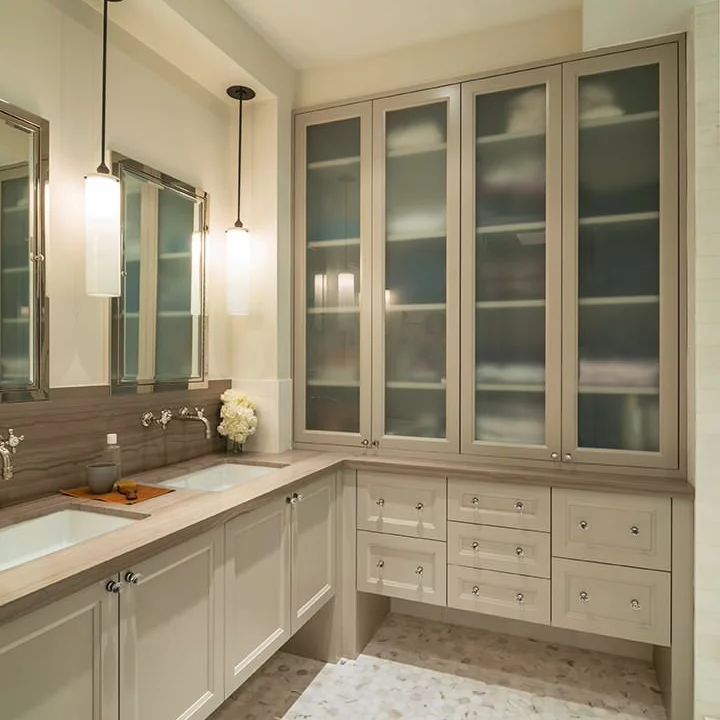 a large bathroom with double sinks and cabinets