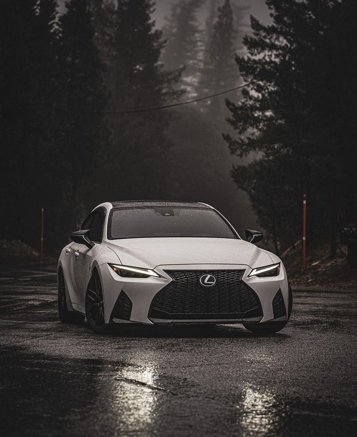 a white sports car parked in the rain