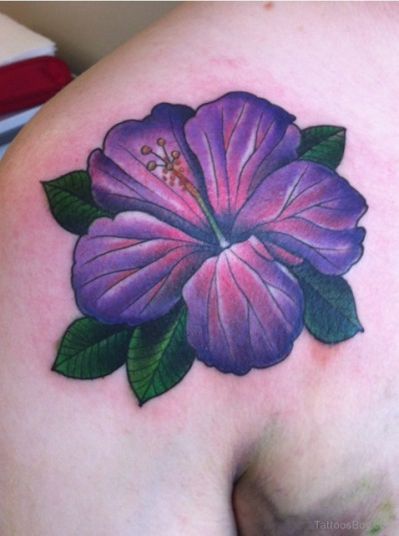 a purple flower on the back of a woman's shoulder