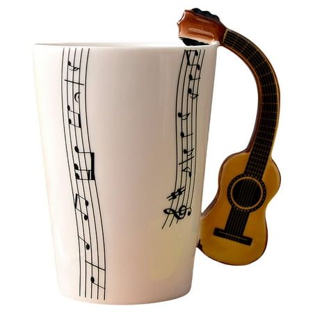 a white coffee mug with musical notes on it and a wooden guitar in the middle