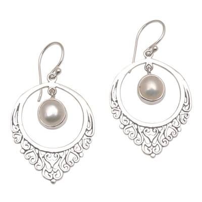 This exquisite pair of earrings is designed and crafted by Balinese artisan Suar Dwipayana. The drop-shaped sterling silver setting features an intricate motif of heart-shaped vines. Dangling gracefully inside its circular confines a dazzling cultured mabe pearl comes to life with every sway and movement while a combination finishes adds a beautiful visual depth. Traditional Sterling Silver Pearl Drop Jewelry, Traditional Round Sterling Silver Pearl Earrings, Traditional Pearl Drop Earrings In Sterling Silver, Traditional Silver Teardrop Pearl Earrings, Intricate Silver Dangle Pearl Earrings, Silver Bohemian Pearl Earrings For Gifts, Silver Dangle Pearl Earrings With Intricate Design, Silver Intricate Dangle Pearl Earrings, Bohemian Silver Round Pearl Earrings