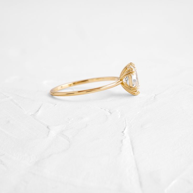 Oval cut focal diamond of your choice. Need help choosing a diamond? Our Customer Care team is right here. This design features an open basket setting with six triple-prongs on a delicate 1.2mm band—available in platinum or 14k solid yellow, white or rose gold. We handcraft each piece with responsibly sourced 14k gold and ethically sourced stones. Minimalist Cluster Ring With Prong Setting, Delicate White Topaz Diamond Ring With Prong Setting, Single Diamond Oval Diamond Ring In 14k Gold, Minimalist Oval Cubic Zirconia Wedding Ring, Modern Oval Diamond Ring With Prong Setting, Dainty Marquise Cut Ring With Prong Setting, Minimalist 14k Gold Cluster Ring With Prong Setting, Single Diamond Oval 14k Gold Ring, Minimalist Oval Wedding Ring With Prong Setting