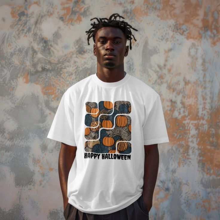 Embrace the spooky season in style with this African tribal-inspired pumpkin print t-shirt featuring a joyful Halloween quote. Perfect for parties, trick-or-treating, and celebrating your culture in a subtle yet striking way. Stand out this Halloween with our unique African tribal-themed t-shirt, complete with a festive pumpkin print and cheerful seasonal quote. Ideal for adding a touch of your heritage to the spookiest time of year. Elevate your Halloween wardrobe with this eye-catching tee, bl Halloween White Graphic T-shirt, White Halloween T-shirt With Graphic Design, White Graphic T-shirt For Halloween, White Halloween Graphic Design T-shirt, Retro Halloween Streetwear Tops, Halloween Graphic Design Short Sleeve T-shirt, Fun Halloween Graphic Print T-shirt, Retro Halloween Short Sleeve Tops, White Tops With Halloween Graphic Design