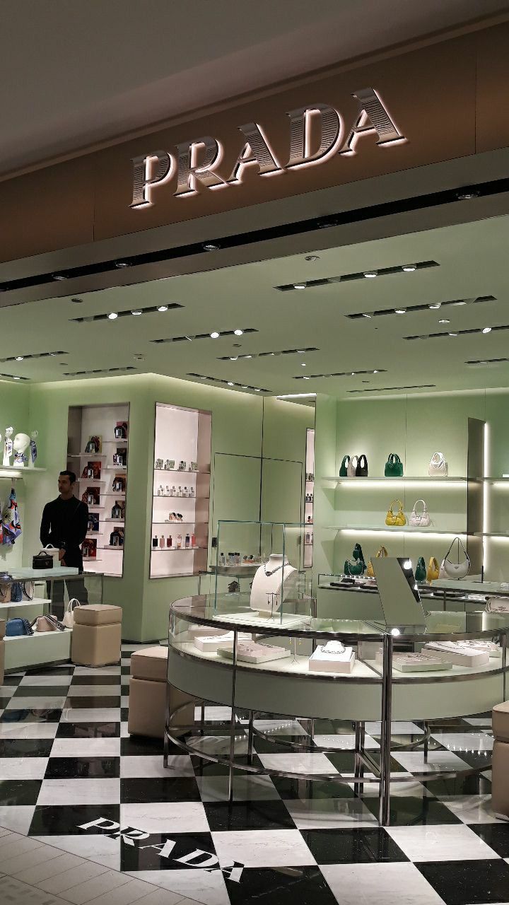 the inside of a prada store with black and white checkered floor