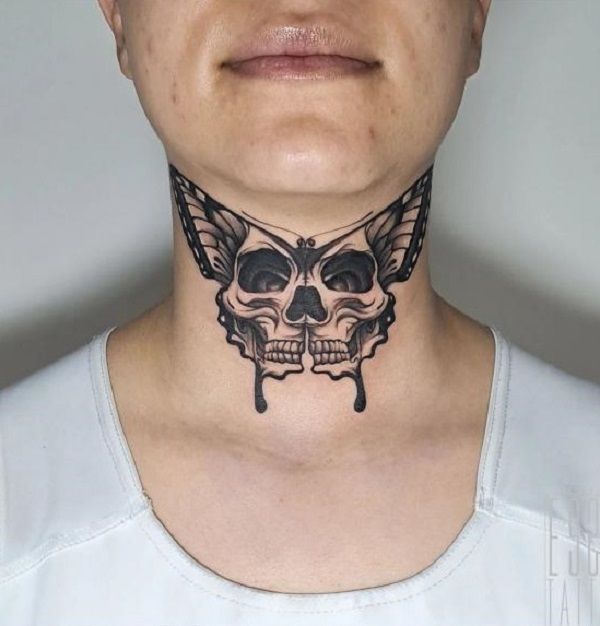 a woman with a butterfly tattoo on her neck