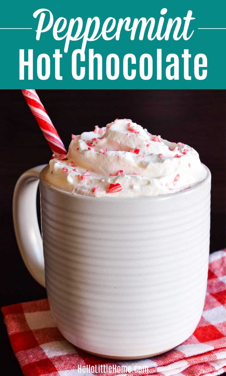 peppermint hot chocolate in a mug with whipped cream and candy cane