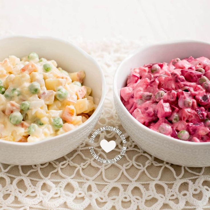 two white bowls filled with food on top of a lace doily next to each other