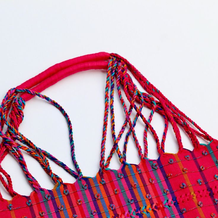 This unique bag is beautifully made on a waist loom, (Telar de Cintura) by artisans from Chiapas México. Each bag is individually handwoven with a unique colors and designs . There is not other like it! Use this reusable and eco-friendly, 100% cotton loom tote bag as a shopping bag for farmer's markets . Dress it down with a t-shirt and jeans or shorts! or to add a boho vibe to any outfit. Details: Tote measurements: 14 x 16.5 inch Handle drop: 10" Material: 100% Cotton Color: hot pink with colo Red Handwoven Beach Bag For Shopping, Red Handwoven Beach Bag For Market, Multicolor Woven Beach Bag For Festival, Pink Handwoven Bags For Festival, Pink Handwoven Festival Bags, Handmade Multicolor Beach Bag For Festivals, Handwoven Multicolor Beach Bag For Festival, Multicolor Handwoven Beach Bag For Festival, Eco-friendly Multicolor Handwoven Beach Bag