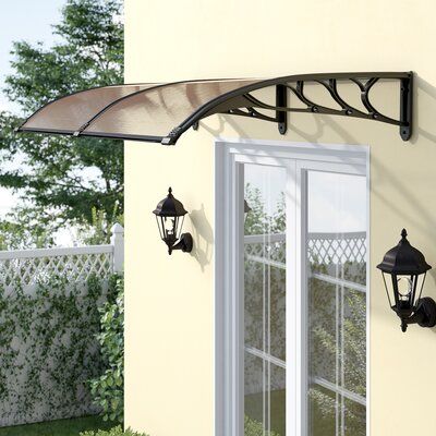 an awning over a patio door with two lights on the outside and one light on the inside