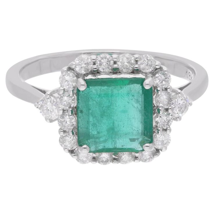 Immerse yourself in the enchanting beauty of this Zambian Emerald Gemstone Ring, an exquisite piece of handmade fine jewelry meticulously crafted in luxurious 18 Karat White Gold. Radiating elegance and sophistication, this ring is adorned with stunning diamonds, perfectly complementing the allure of the majestic emerald centerpiece. The ring is a size 7 US and may be resized to larger or smaller upon request. FOLLOW SPECTRUM JEWELS storefront to view the latest collection & exclusive pieces. Sp Luxury Cluster Diamond Ring With Gemstone, Luxury White Gold Gia Certified Gemstones, Luxury Gia Certified White Gold Gemstones, Emerald Ring With Center Stone In 14k White Gold, Luxury Emerald Gemstones With Accent Stones, Elegant Diamond Gemstones For Anniversary, Gia Certified Platinum Gemstones Fine Jewelry, Elegant Emerald Ring With Halo Design For Formal Occasions, Elegant Emerald Ring With Halo Design For Formal Events