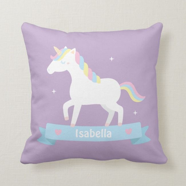 a purple pillow with a white unicorn on it and the words lasabella in blue