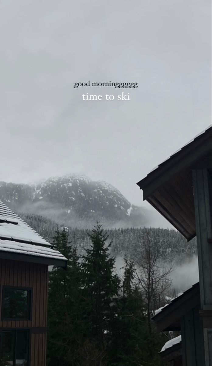 the mountains are covered in snow and there is a time to ski sign above them