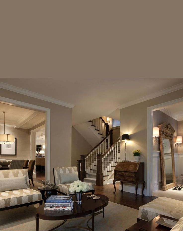 a living room filled with furniture and a stair case