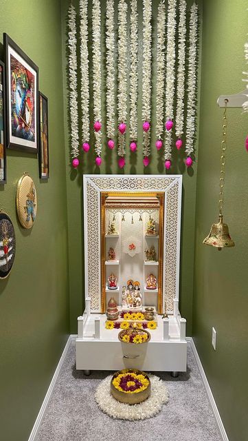 a small shrine is decorated with flowers and garlands