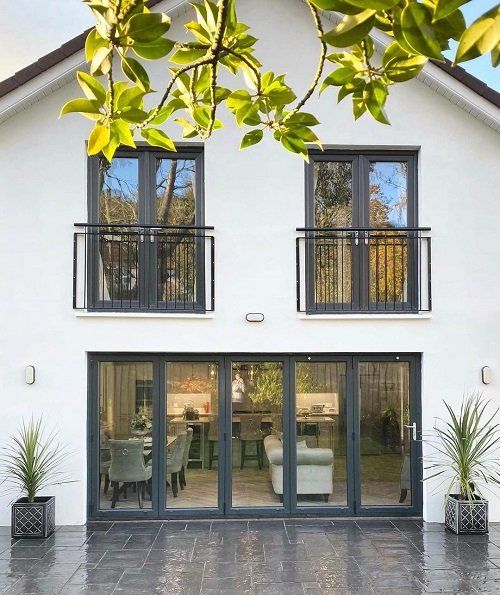 a large white house with black windows and doors