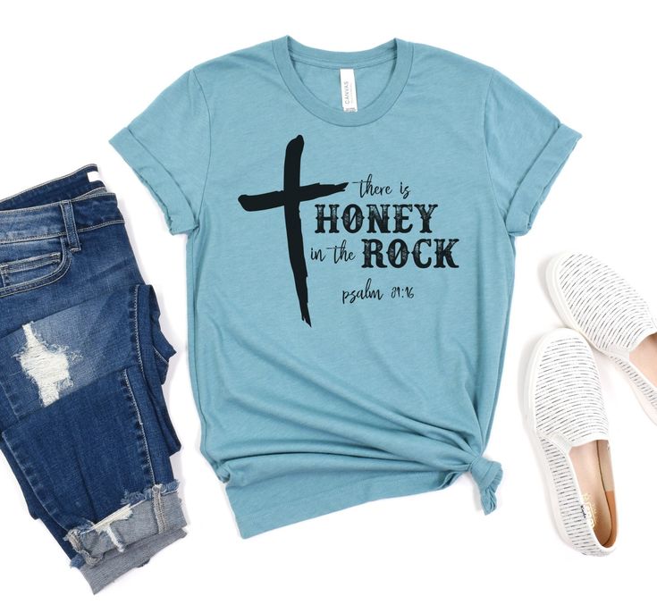 Show off your style this summer wearing this cute There Is Honey In The Rock Tee! ▪️ Please refer to the size chart for sizing  ▪️ Shirts are made using sublimation, which is permanently pressed into the fibers of the shirt  ▪️ Soft & Comfortable Shirts  ▪️ Bella Canvas 52% Cotton / 48% Polyester - Heather Blue Lagoon Care Instructions:  Wash inside out, delicate cycle, lay flat to dry. Check out my shop for more fun items!  https://www.etsy.com/shop/tealcottageboutique Summer Band Merch Shirt With Letter Print, Summer Band Merch Cotton Shirt, Unisex Text Print Shirt For Summer, Band Merch Cotton Shirt For Summer, Summer Unisex Text Print Shirt, Summer Text Print Shirt, Summer Cotton Shirt With Band Merch, Honey In The Rock, Boutique Owner