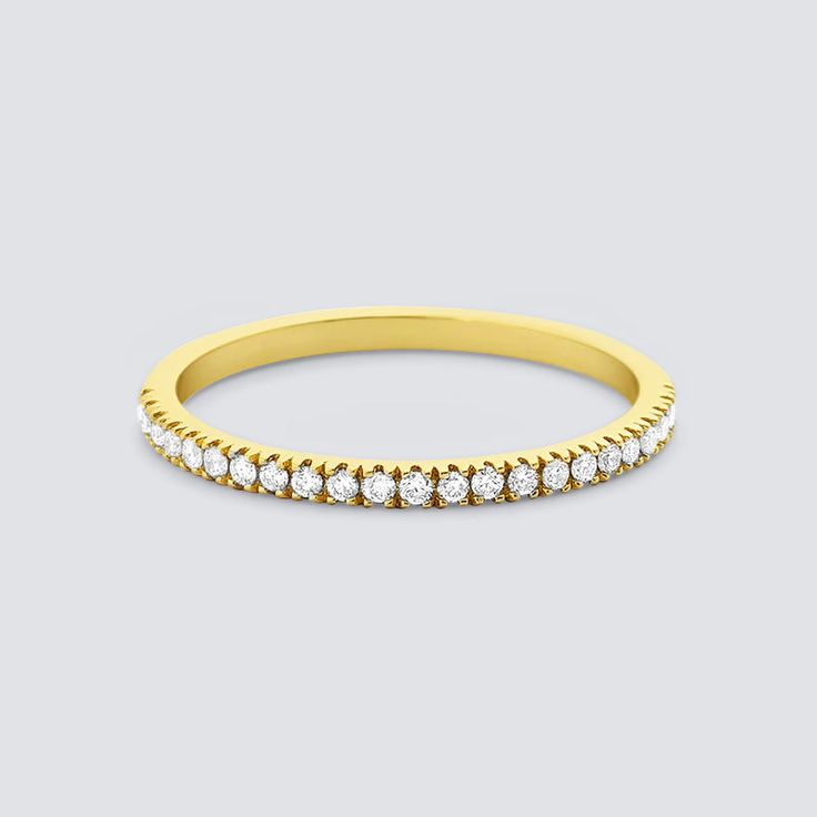 DESCRIPTION & DETAILS Shine bright with the elegant beauty of this eternity ring. Delicately handcrafted to perfection and it is adorned with a row of dazzling diamonds to create a fine line of brilliance. Solid 14K Gold Vermeil Materials: 14k Gold on Sterling Silver, Moissanite Crystals Hypoallergenic SUSTAINABILITYIn-house plating - All pieces are hand crafted by our in-house jewellers ensuring a high standard of working conditions.Fair pricing - Due to our ethical manufacturing ways and cutti Dazzling Cubic Zirconia Half Eternity Diamond Ring, Dazzling Cubic Zirconia Half Eternity Ring, Half Eternity Band Promise Ring, Half Eternity Moissanite Band, Classic Stackable Rings With Pave Setting, Dazzling Moissanite Half Eternity Rings, Classic Vvs Clarity Eternity Band, Yellow Gold Lab-grown Diamond Eternity Band Promise Ring, Classic Cubic Zirconia Half Eternity Stackable Rings