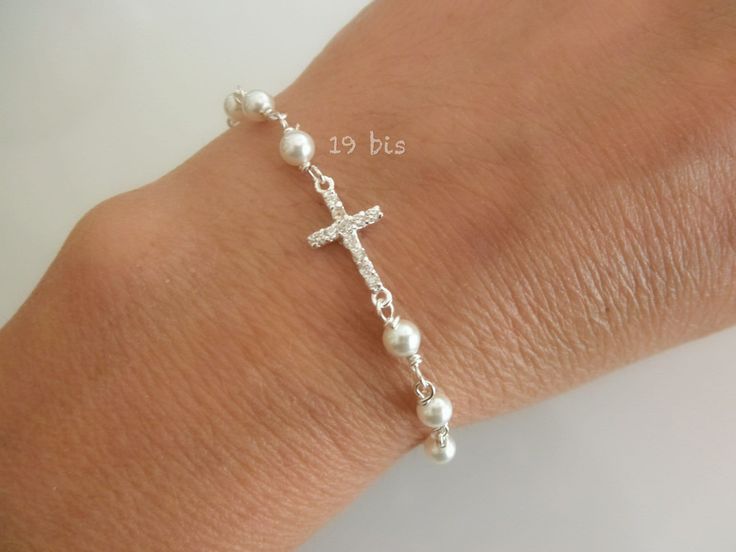 Pearl bracelet with zircon cross DE T A I L S  ✦ available in silver ✦ cross: 13mm ✦ chain: flat cable ✦pearls: 4mm Swarovski pearls (3 pearls on each side)       L E N G T H  choose the length you need from the drop down menu ✦ comes with 0.5" chain extender M A T E R I A L ✦ 925 solid sterling silver ✦ pearls: Swarovski pearls ✦ cubic zirconia N O T E S 📌 19bis wants to make sure every customer is satisfied with their purchase. Please let us know if you have any   questions, we are always ava Elegant Sterling Silver Cross Rosary Bracelet, Elegant Silver Pearl Bracelet For Baptism, Elegant Cross Rosary Bracelet For Wedding, Elegant Cross-shaped Rosary Bracelet For Wedding, Elegant White Cross Bracelets, Elegant White Cross Bracelet, Elegant Silver Bracelets For First Communion, Elegant Silver Bracelet For First Communion, Silver Elegant Rosary Bracelet For First Communion