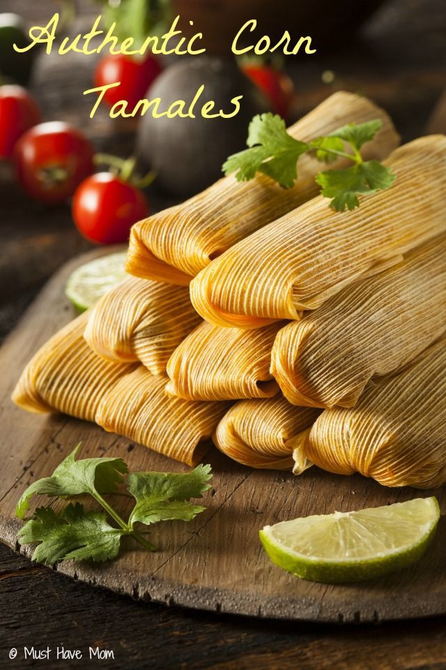 some tamales are stacked on top of each other with limes and cilantro