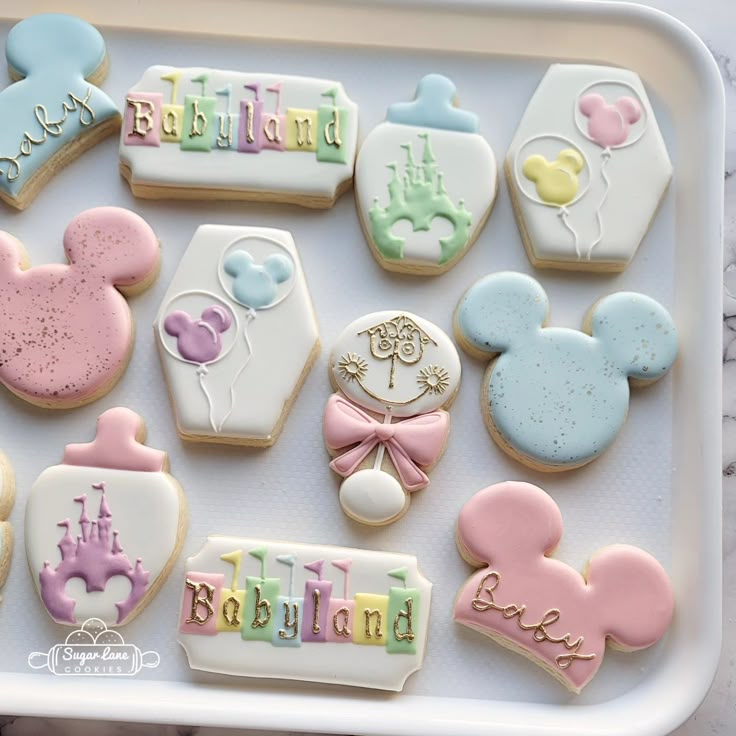 decorated cookies in the shape of mickey and minnie mouses for a baby's first birthday