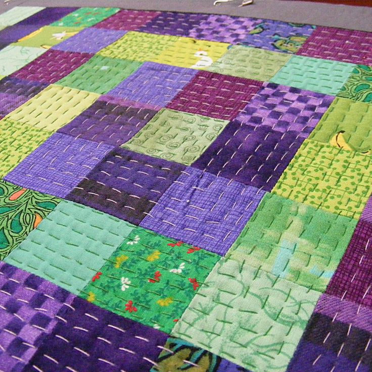 a close up of a quilt on the floor