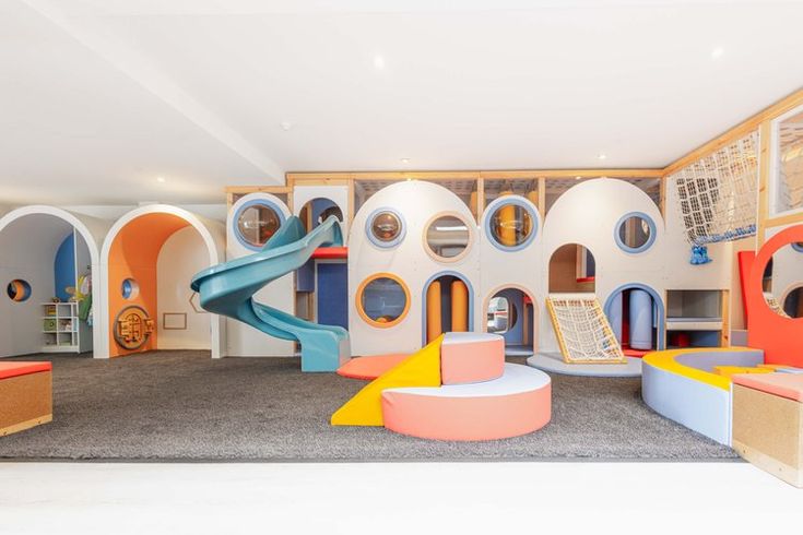 the children's play area has been decorated in bright colors and features an indoor slide