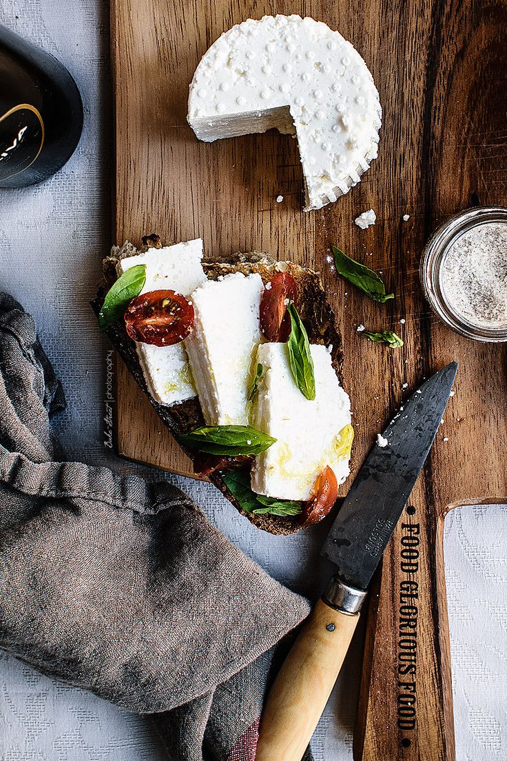 there is a piece of bread with cheese on it and a knife next to it