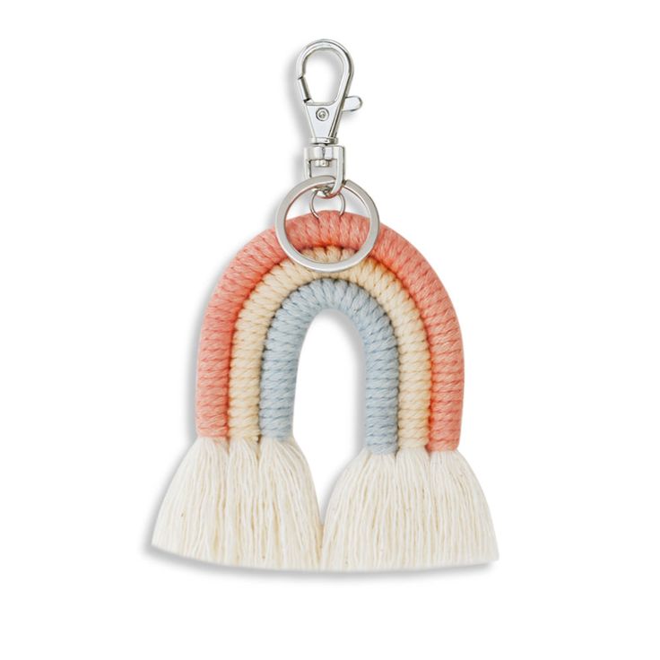 a keychain with two rainbows hanging from it's sides, one in white and the other in pink