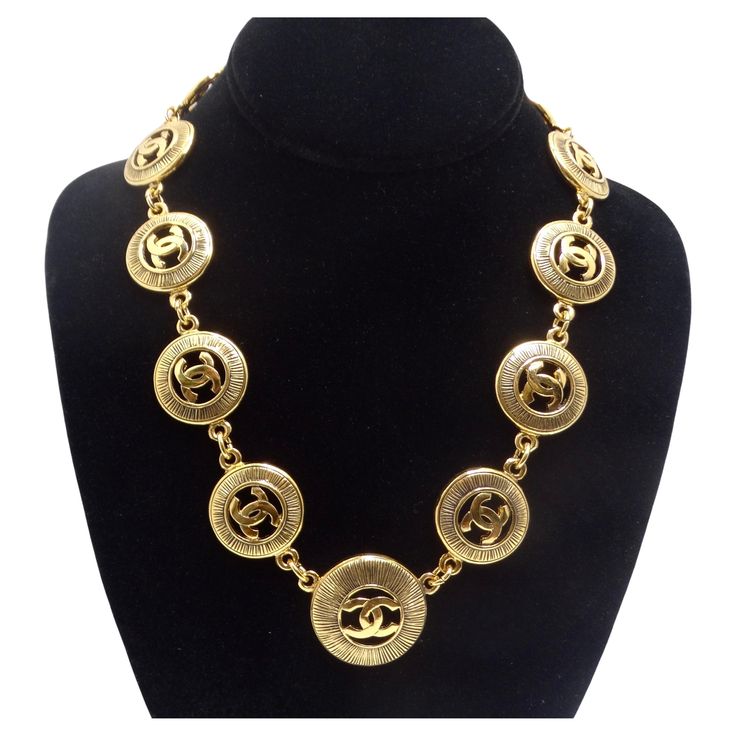 Introducing a stunning piece of vintage elegance, the Chanel 1980s Logo Medallion Necklace. This necklace features 11 gold-plated Chanel signature CC logo cutout charms with a sunburst pattern. The iconic interlocking 'C' logos are a symbol of timeless sophistication and luxury, making this piece unmistakably Chanel. Dating back to the 1980s, this necklace carries a sense of vintage charm and authenticity. It's a unique piece of fashion history that adds character and style to your ensemble. The adjustable closure ensures a perfect fit, allowing you to customize the length according to your preference. The spring lobster closure provides both security and ease of wear. The gold-plated charm design makes this necklace a versatile accessory that complements various styles and occasions. Whet Luxury Antique Chain Necklace, Luxury Vintage Clavicle Chain Jewelry, Luxury Timeless Medallion Necklace, Luxury Vintage Medallion Jewelry, Classic Luxury Channel Set Necklace, Vintage Chanel Necklace, Chloe 2024, Rhinestone Costume, Fendi Bracelet