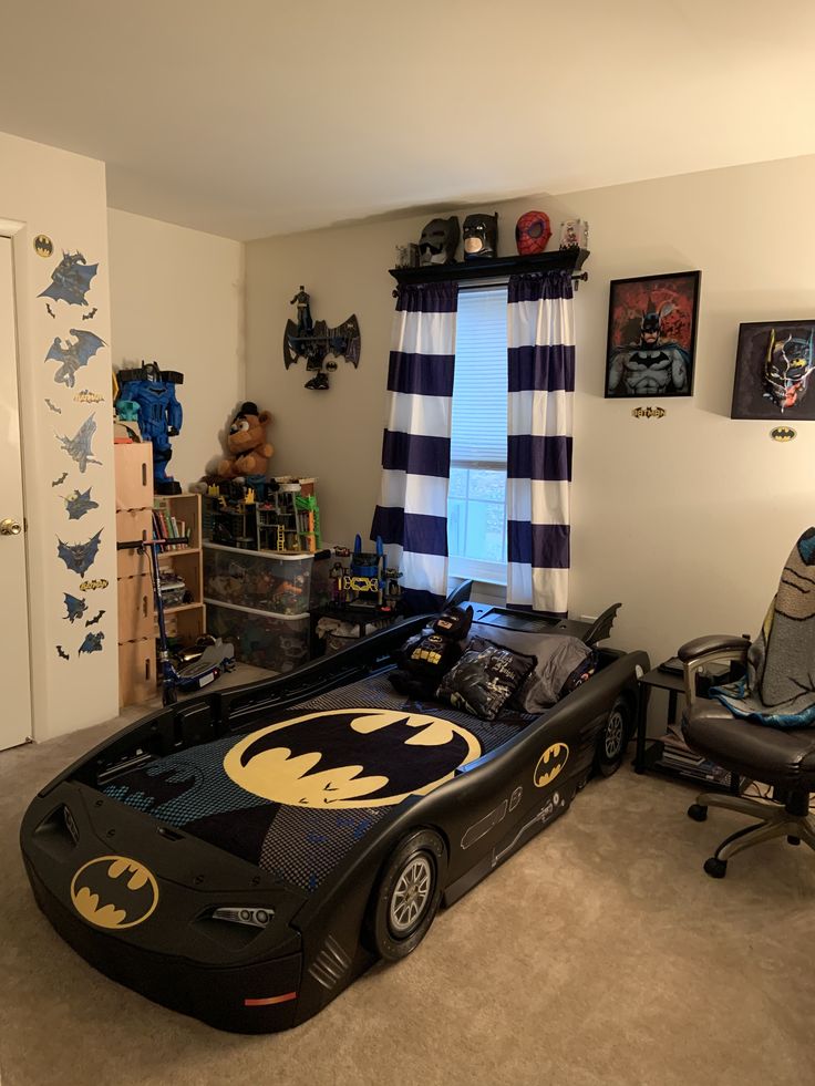 a child's bedroom with batman car bed