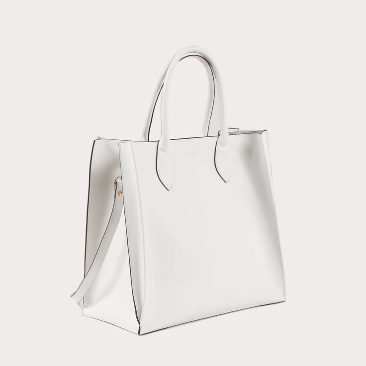 As worn by Kris Jenner, The Dee Holdall Tote elevates the expectations of a tote bag. Featuring a removable interior pocket and removable shoulder strap, this tote is as good at multitasking as you are. The structured silhouette and timeless 100% fine Italian leather make this tote a classic addition to every outfit. White Made in Italy 100% Leather Measures (Width-Height-Depth): 36x34x18 cm Office Shoulder Bag With Double Handle And Dust Bag, Timeless White Bag For Daily Use, Timeless White Satchel For Daily Use, Timeless Bags With Removable Pouch For Shopping, Timeless Bag With Removable Pouch For Shopping, Timeless Satchel With Detachable Strap For Shopping, Timeless Double Handle Shoulder Bag For Shopping, Timeless White Satchel For Everyday Use, Timeless White Satchel For Everyday