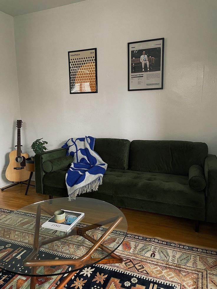 a living room with green couches and rugs