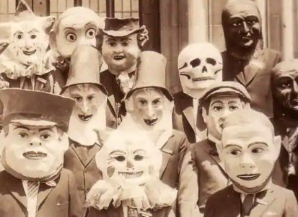 an old black and white photo with many people wearing masks