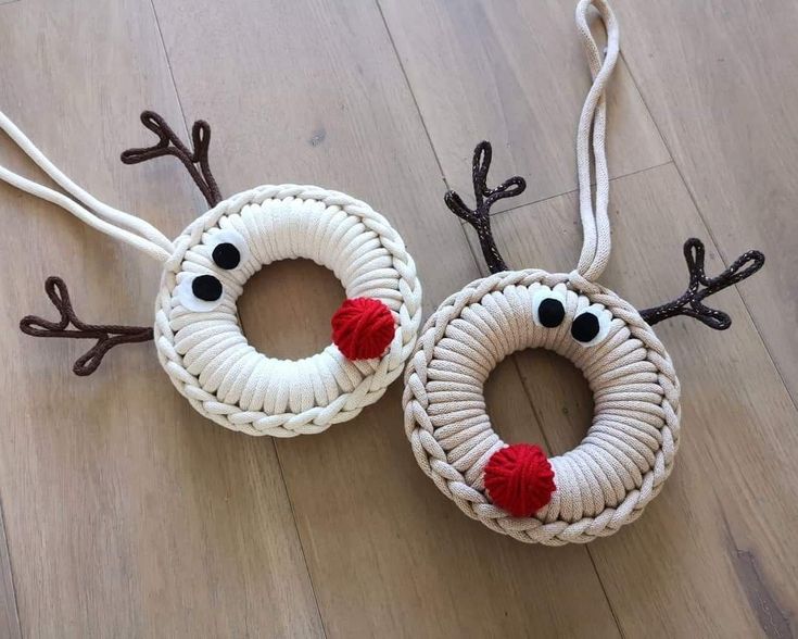 two christmas wreaths made out of rope with reindeer noses and antlers on them