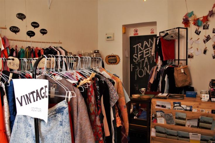 a clothing store with lots of clothes hanging on racks