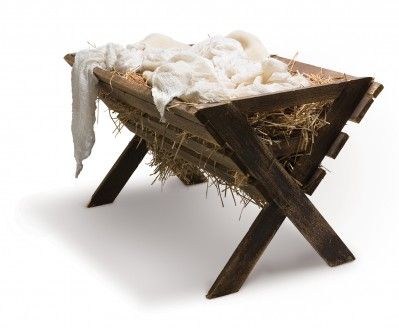 a baby jesus in a manger with hay and cloth on the sides, surrounded by sticks